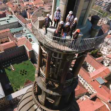 Dettaglio punta cupola di Novara vista dall'alto con sopra delle persone con imbragatura e caschetti